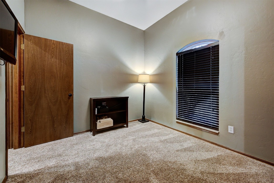 1304 Polly Way, Mustang, OK 73064 interior space with lofted ceiling and light colored carpet