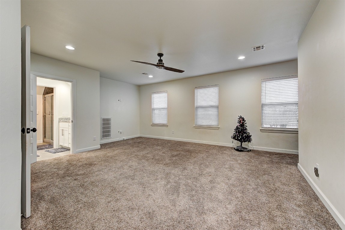 1304 Polly Way, Mustang, OK 73064 spare room with ceiling fan and light colored carpet