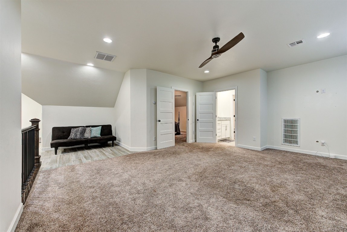 1304 Polly Way, Mustang, OK 73064 carpeted living room featuring ceiling fan and vaulted ceiling