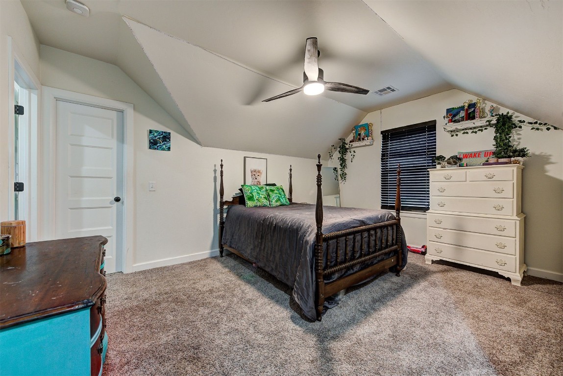 1304 Polly Way, Mustang, OK 73064 carpeted bedroom featuring ceiling fan and vaulted ceiling