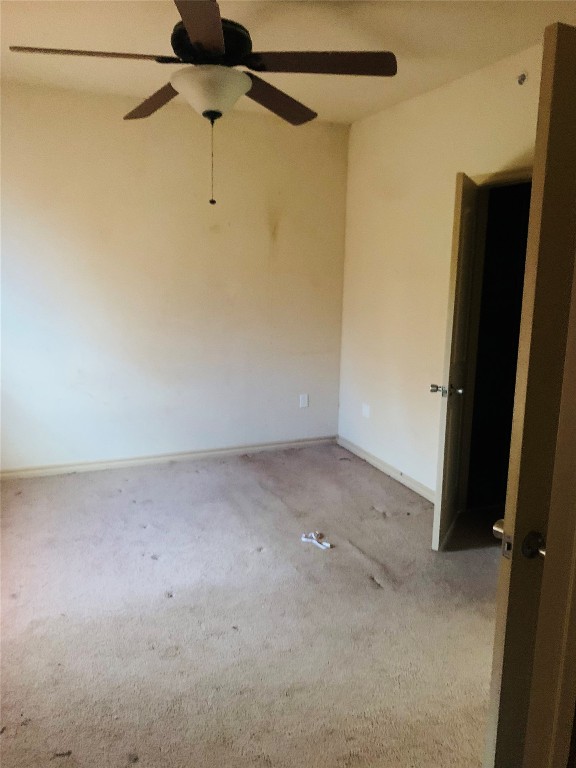 1812 Alameda Street, #316, Norman, OK 73071 spare room featuring ceiling fan and carpet floors