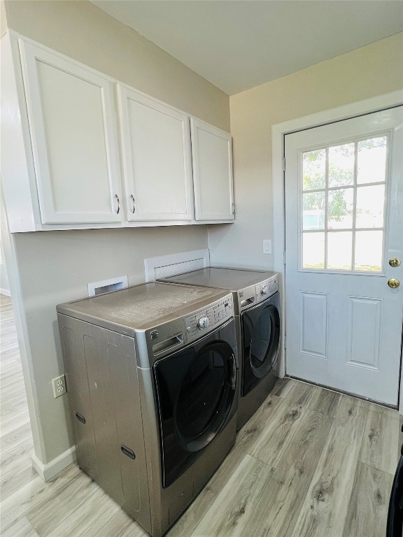 113 Osage Road, #B, Burns Flat, OK 73647 laundry area with cabinets, independent washer and dryer, light hardwood / wood-style floors, and washer hookup