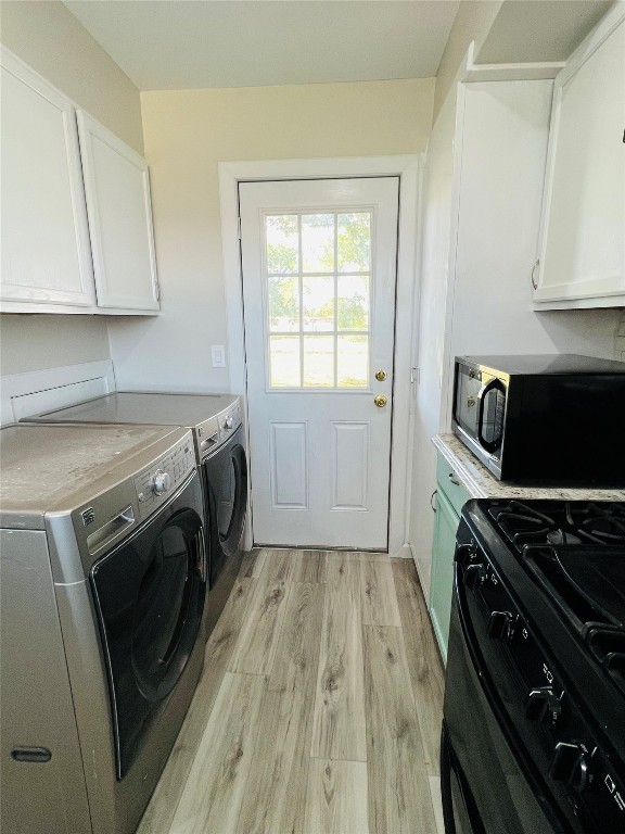 113 Osage Road, #B, Burns Flat, OK 73647 laundry room featuring light hardwood / wood-style flooring and washer and dryer