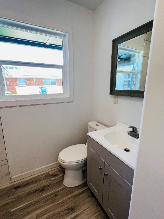 113 Osage Road, #B, Burns Flat, OK 73647 bathroom featuring oversized vanity, toilet, plenty of natural light, and hardwood / wood-style floors