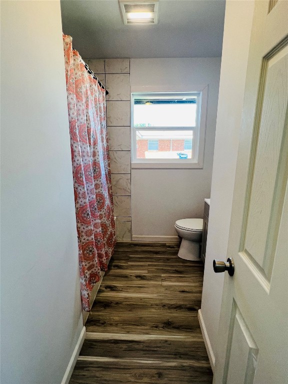 113 Osage Road, #B, Burns Flat, OK 73647 bathroom featuring vanity, toilet, and hardwood / wood-style flooring
