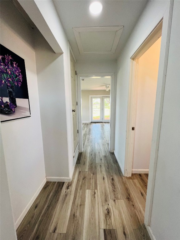 113 Osage Road, #B, Burns Flat, OK 73647 hallway featuring french doors and light wood-type flooring