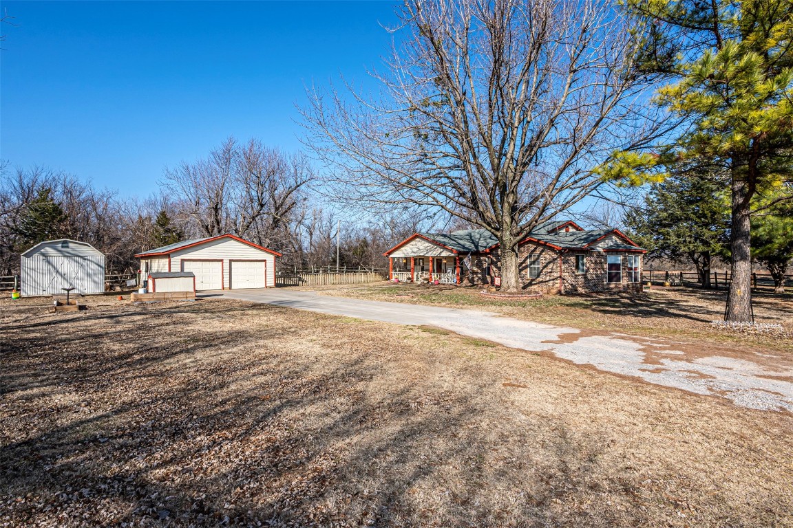 3735 Janet Circle, Mustang, OK 73064 view of yard with a garage and a shed