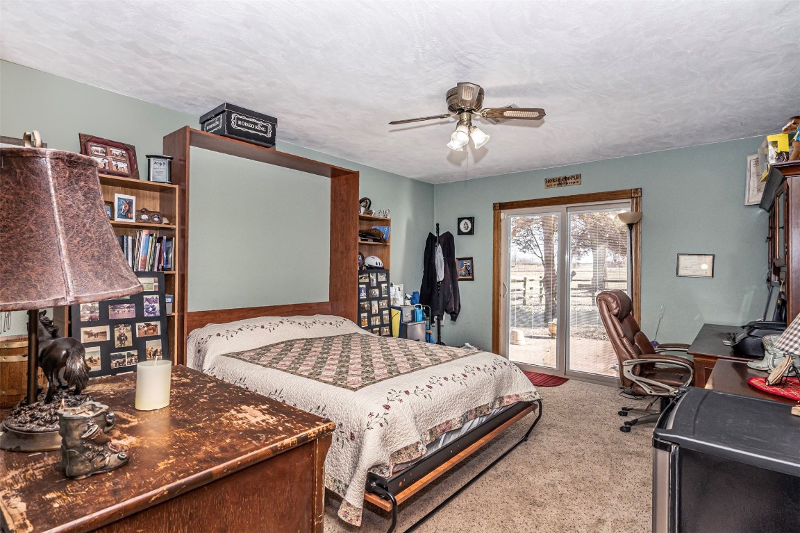 3735 Janet Circle, Mustang, OK 73064 carpeted bedroom featuring a textured ceiling, access to outside, and ceiling fan