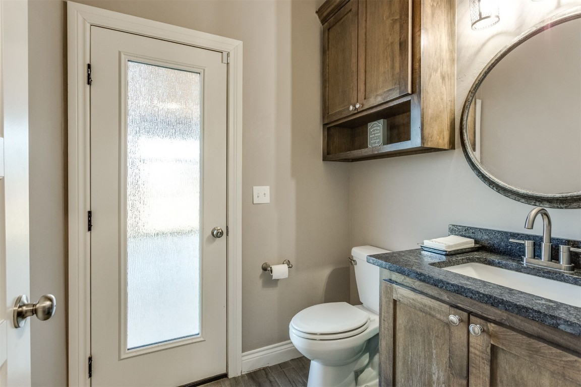 3910 Sienna Ridge, Newcastle, OK 73065 bathroom featuring vanity, toilet, and hardwood / wood-style flooring