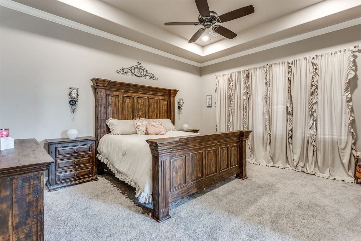 3910 Sienna Ridge, Newcastle, OK 73065 bedroom featuring light colored carpet, a raised ceiling, and ceiling fan