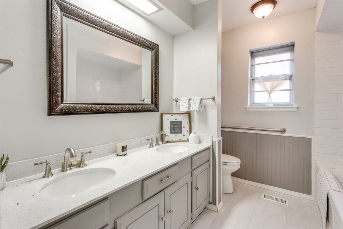 11133 Folkstone Drive, Yukon, OK 73099 bathroom featuring tile floors, toilet, and dual vanity