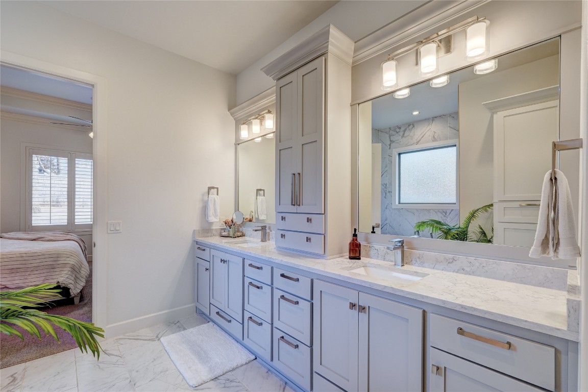 5008 Isle Bridge Court, Edmond, OK 73034 bathroom featuring ornamental molding, double sink vanity, tile flooring, and ceiling fan
