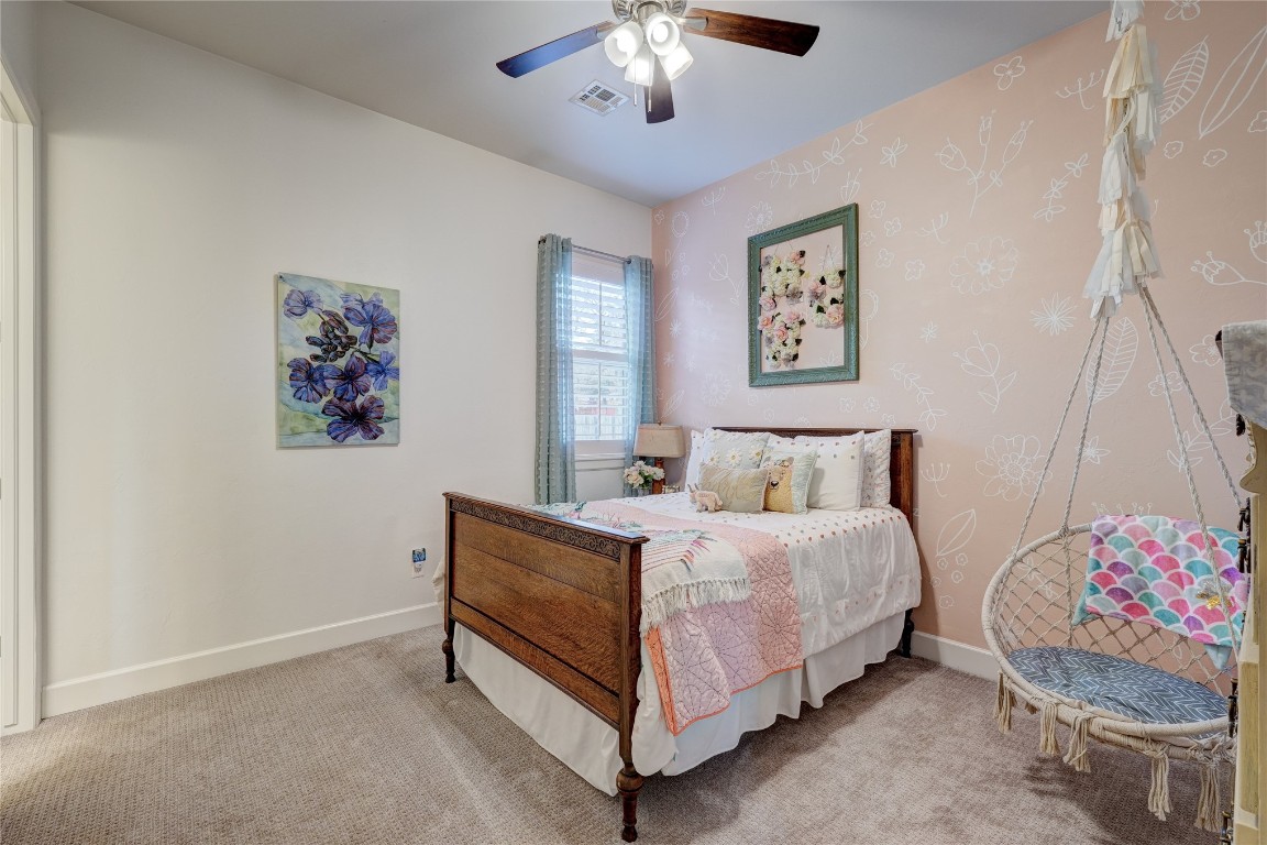 5008 Isle Bridge Court, Edmond, OK 73034 carpeted bedroom with ceiling fan