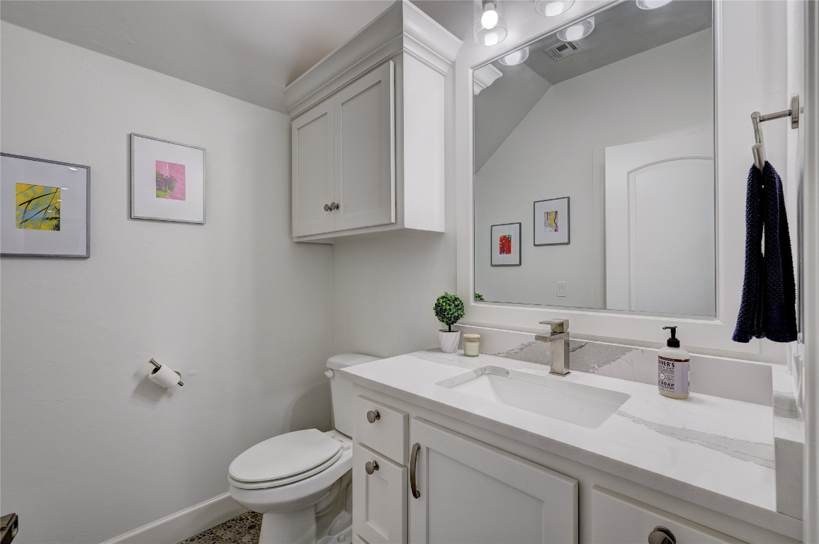 5008 Isle Bridge Court, Edmond, OK 73034 bathroom with vaulted ceiling, vanity, toilet, and tile floors