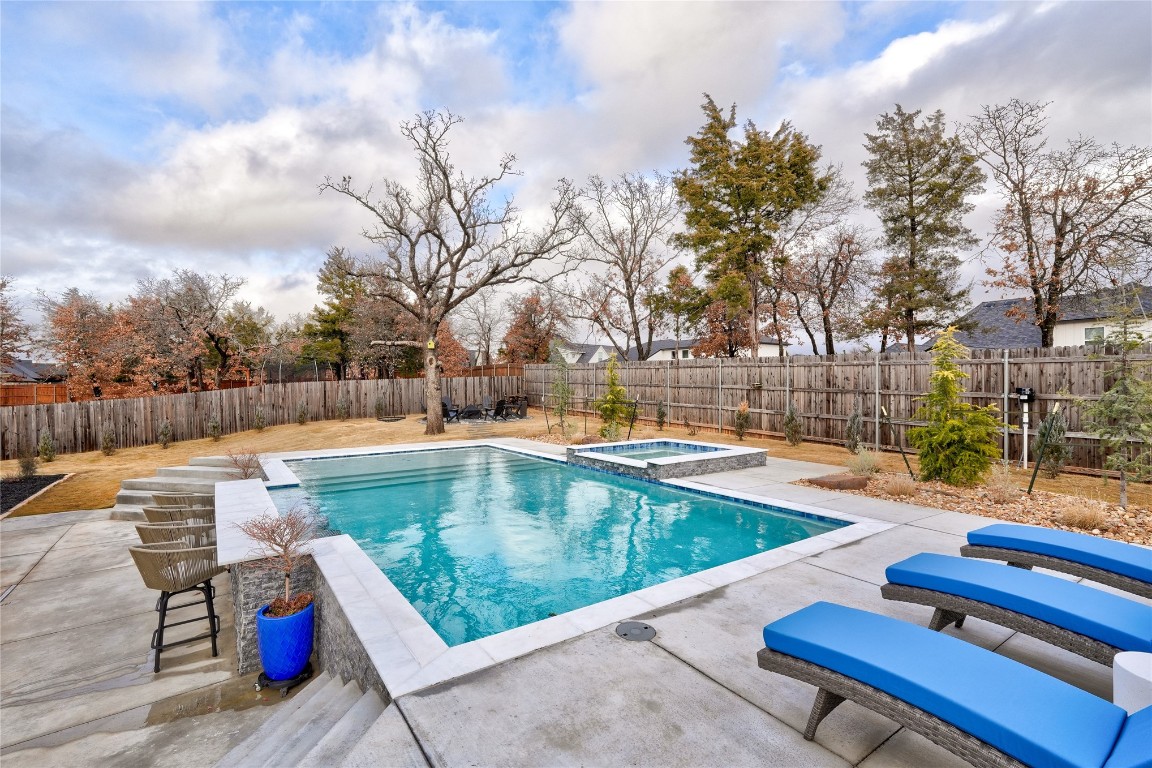 5008 Isle Bridge Court, Edmond, OK 73034 view of pool with an in ground hot tub and a patio