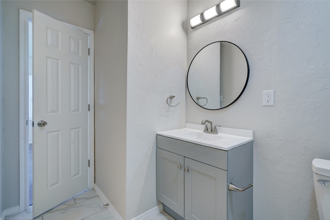 2817 SE 56th Street, Oklahoma City, OK 73129 bathroom featuring tile floors, toilet, and large vanity
