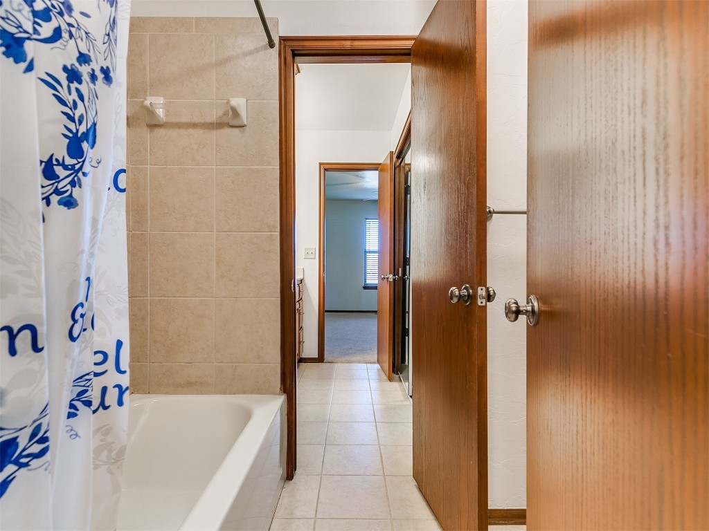 12400 Olivine Terrace, Oklahoma City, OK 73170 bathroom featuring tile floors and shower / bath combo