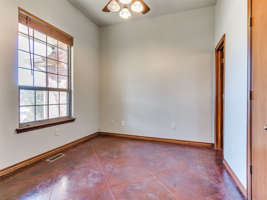 12400 Olivine Terrace, Oklahoma City, OK 73170 empty room with dark tile floors and ceiling fan