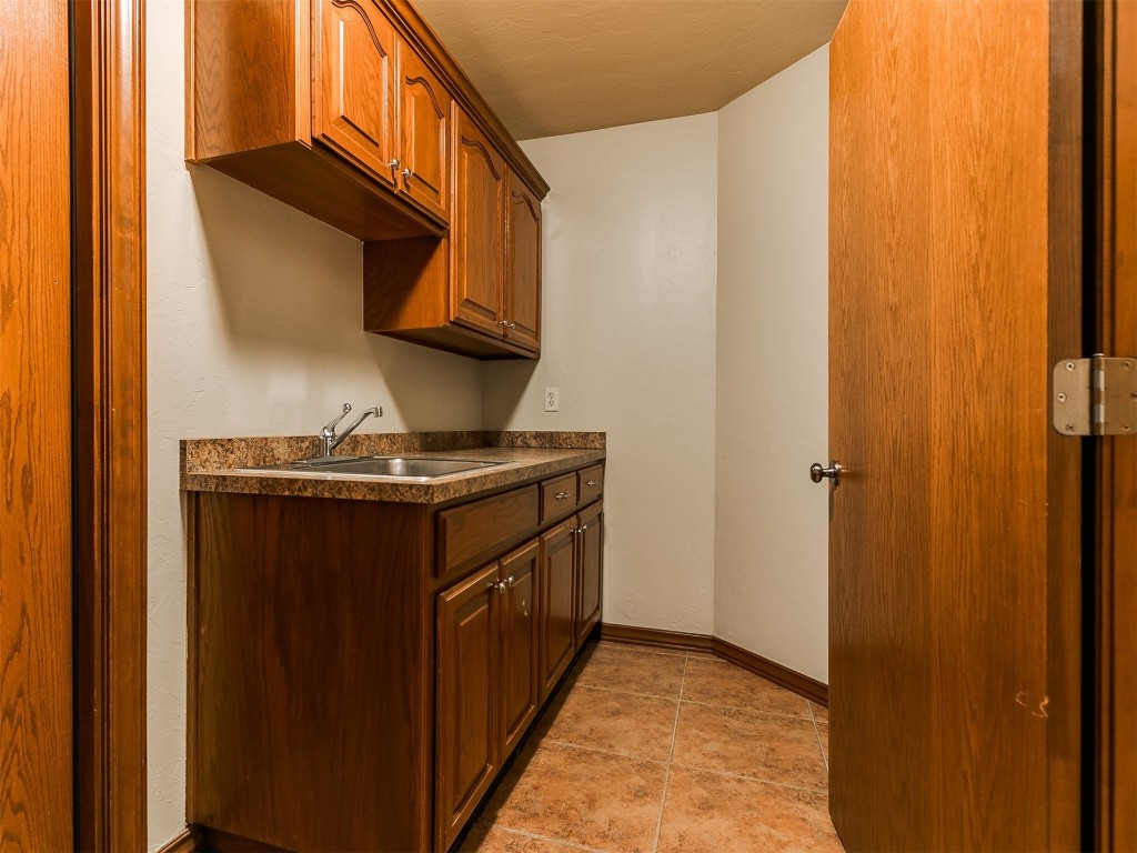 12400 Olivine Terrace, Oklahoma City, OK 73170 kitchen featuring sink and light tile flooring