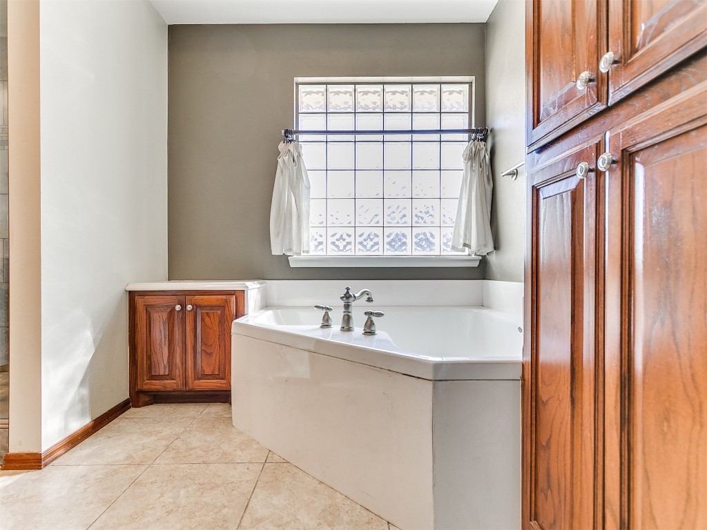 12400 Olivine Terrace, Oklahoma City, OK 73170 bathroom featuring a bath, tile flooring, and plenty of natural light