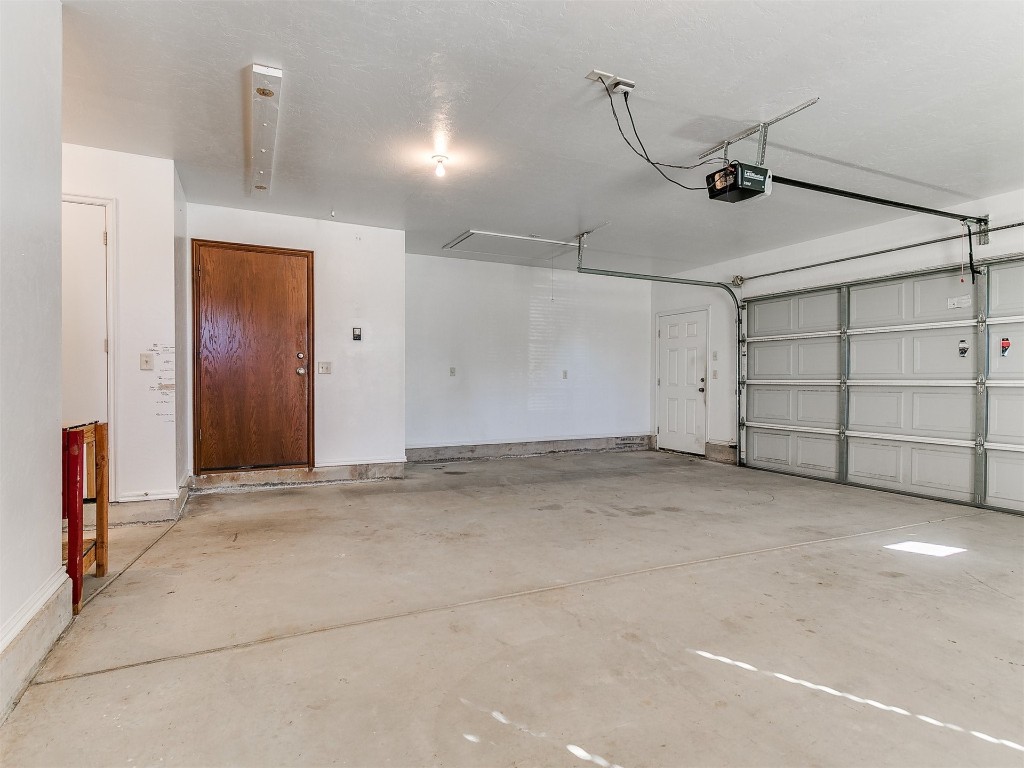 12400 Olivine Terrace, Oklahoma City, OK 73170 garage featuring a garage door opener
