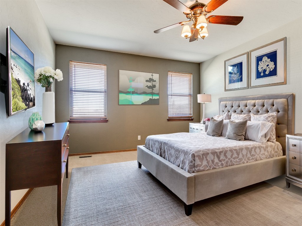 12400 Olivine Terrace, Oklahoma City, OK 73170 bedroom featuring multiple windows, light colored carpet, and ceiling fan