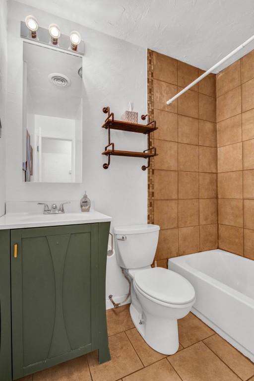 5700 NW 67th Street, Warr Acres, OK 73132 full bathroom featuring tiled shower / bath, toilet, tile flooring, and vanity