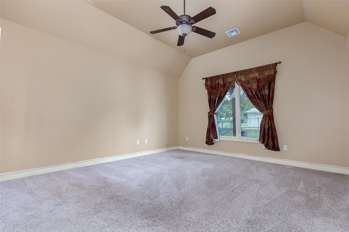 4508 Jacobs Lane, Choctaw, OK 73020 carpeted spare room featuring ceiling fan and lofted ceiling