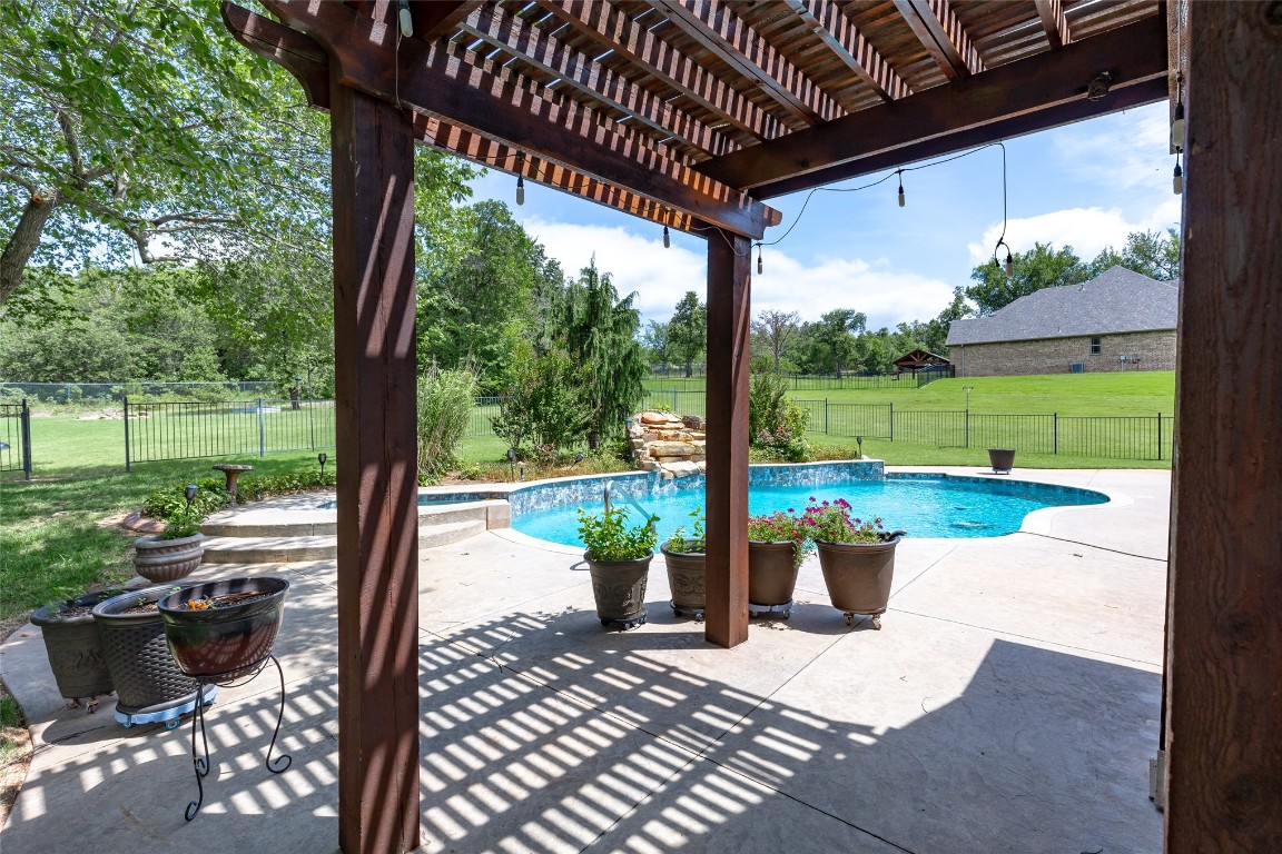 4508 Jacobs Lane, Choctaw, OK 73020 view of swimming pool featuring a pergola, a patio, and a yard