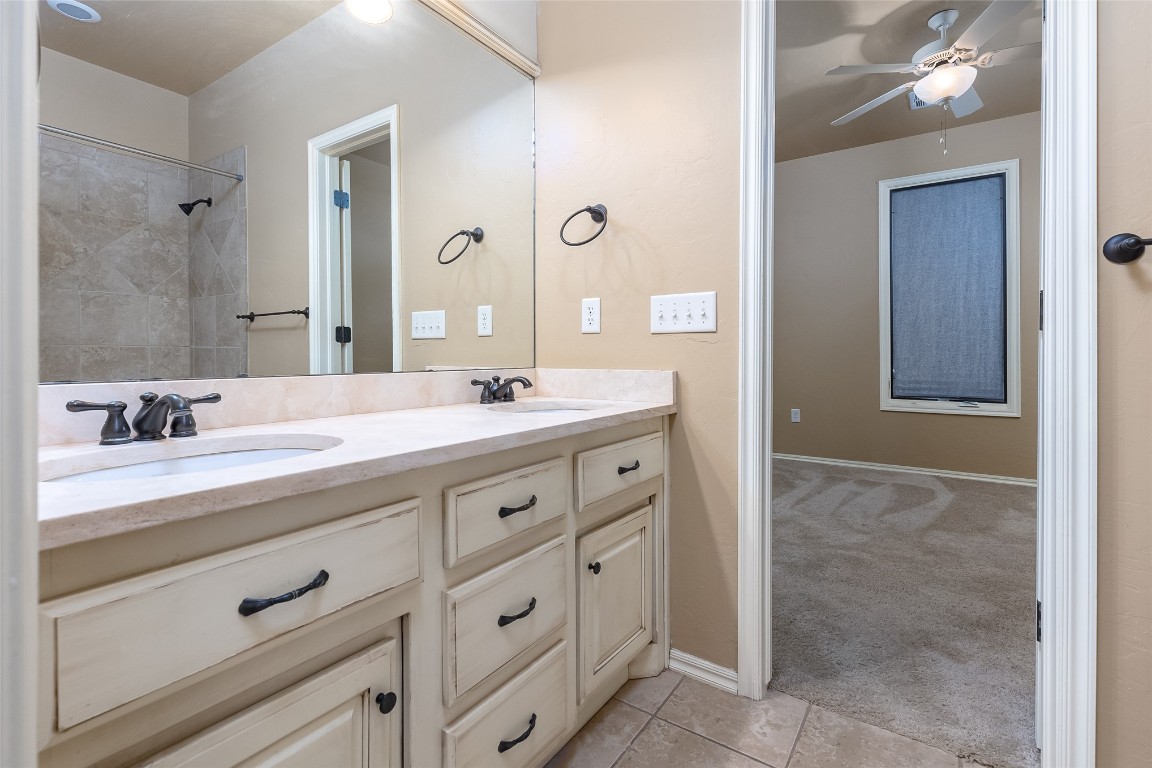 4508 Jacobs Lane, Choctaw, OK 73020 bathroom with dual sinks, large vanity, tile flooring, and ceiling fan