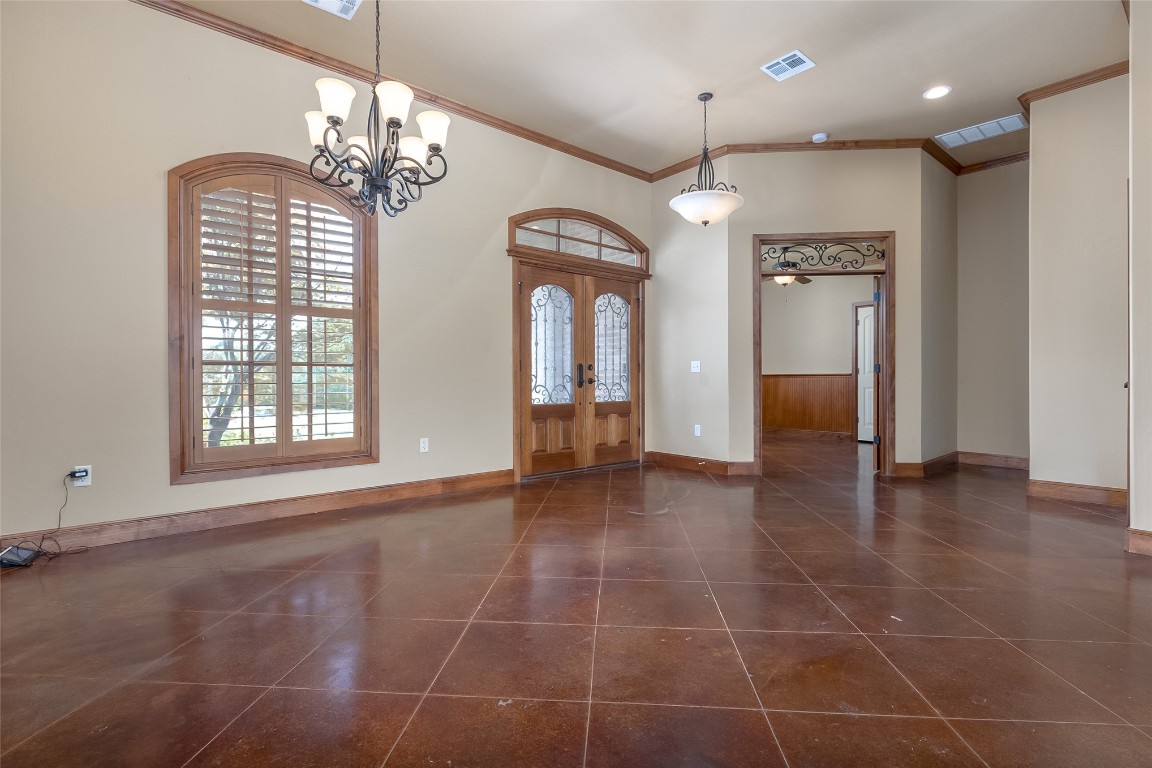 4508 Jacobs Lane, Choctaw, OK 73020 tiled entryway featuring an inviting chandelier, crown molding, high vaulted ceiling, and french doors