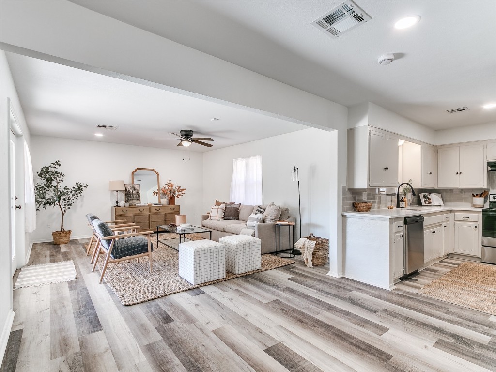 908 NW Van Buren Avenue, Piedmont, OK 73078 living room featuring light hardwood / wood-style floors, ceiling fan, and sink