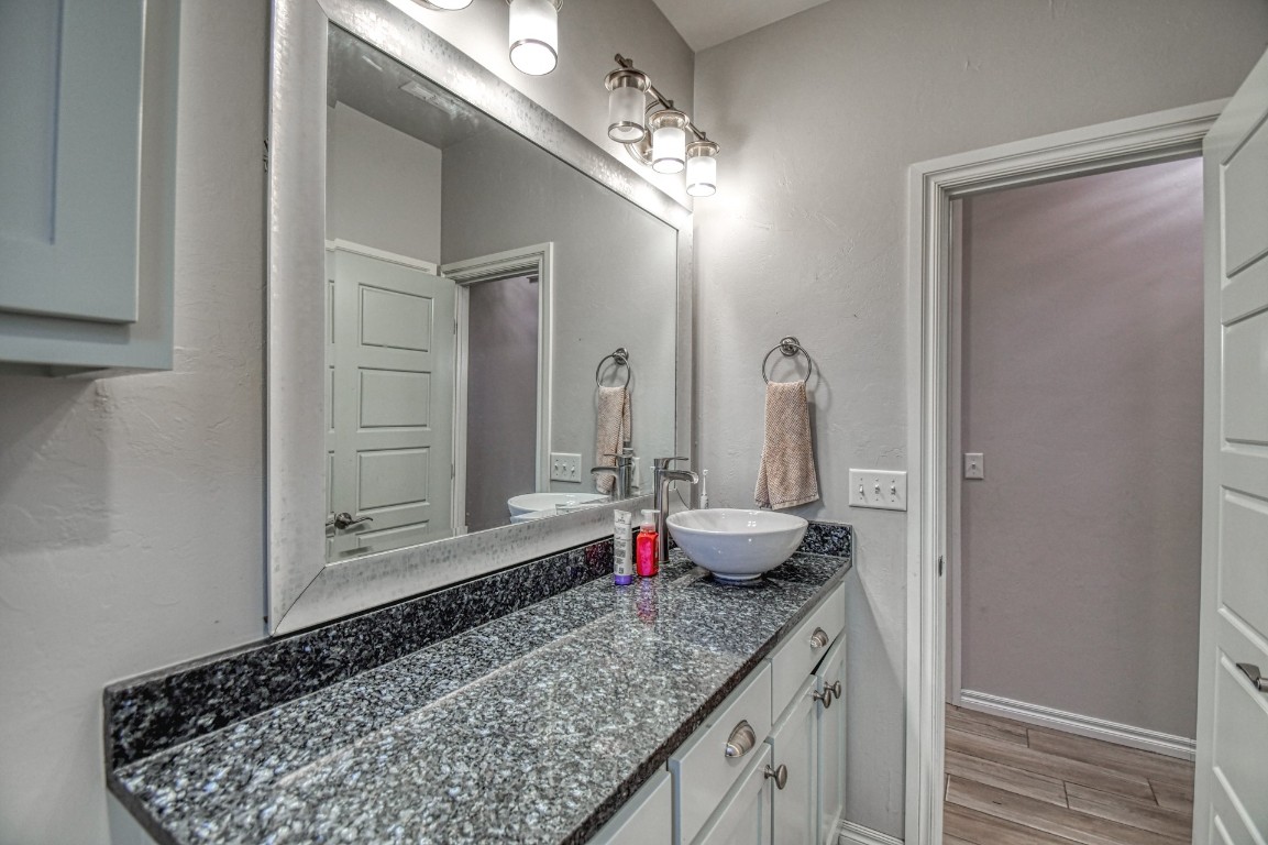 3935 Huntington Parkway, Choctaw, OK 73020 bathroom with large vanity and hardwood / wood-style floors