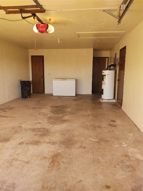 1240 COUNTY Road, Carnegie, OK 73015 garage featuring water heater, fridge, and a garage door opener