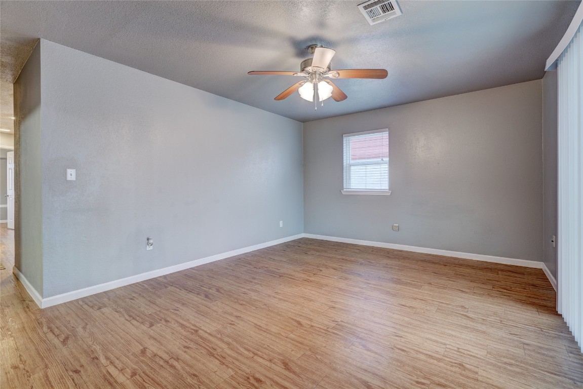 44 SE 57th Street, Oklahoma City, OK 73129 spare room with light hardwood / wood-style floors, ceiling fan, and a textured ceiling