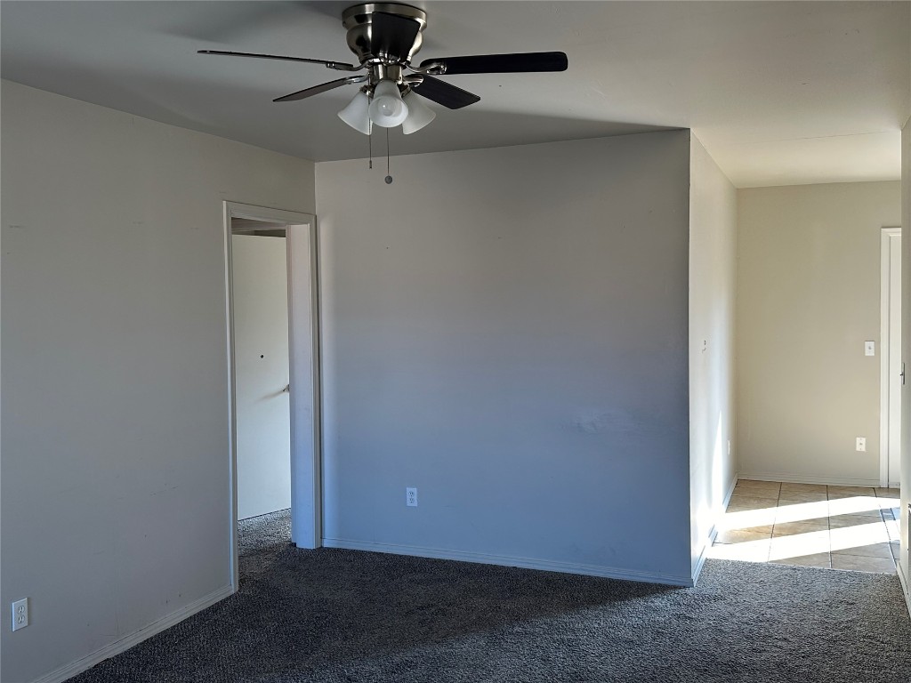 2500 SE 47th Street, Oklahoma City, OK 73129 empty room with dark carpet and ceiling fan
