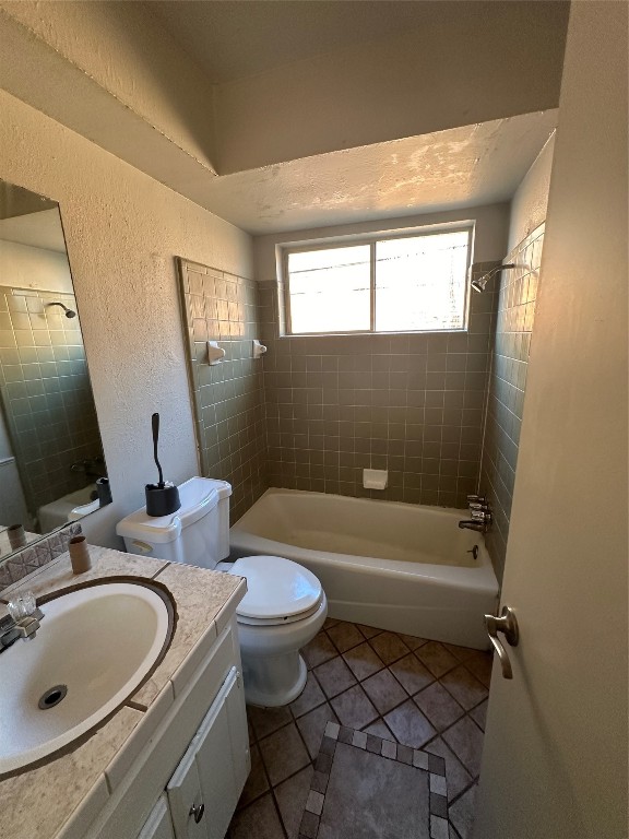 2500 SE 47th Street, Oklahoma City, OK 73129 full bathroom featuring tiled shower / bath, vanity, tile flooring, and toilet