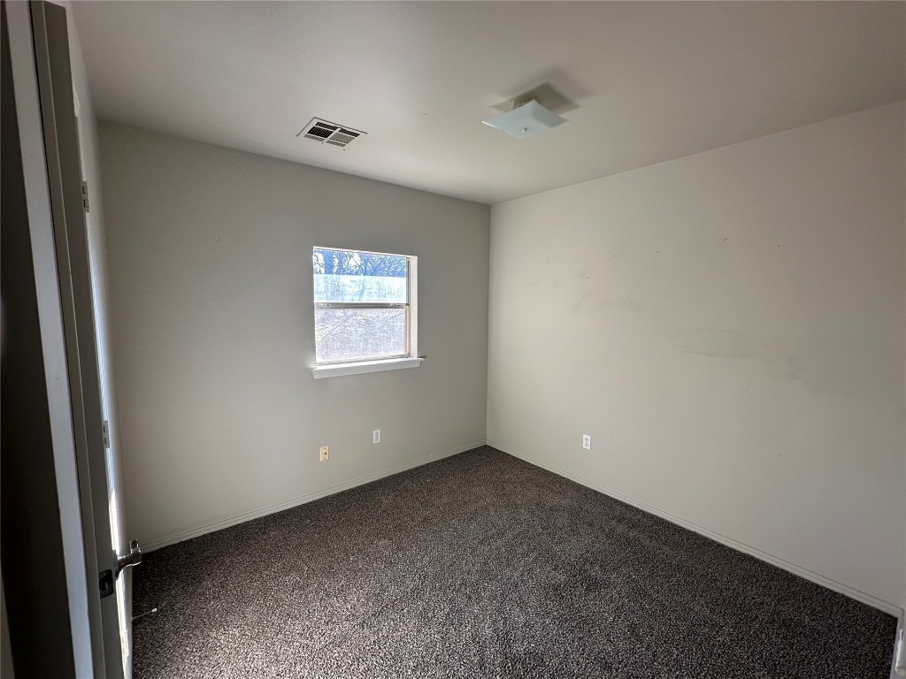 2500 SE 47th Street, Oklahoma City, OK 73129 unfurnished room with dark carpet