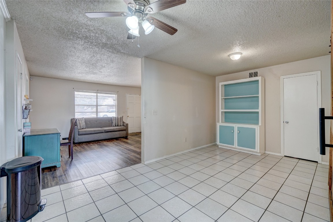 2505 N Hammond Avenue, Oklahoma City, OK 73127 spare room with light tile floors, ceiling fan, and a textured ceiling