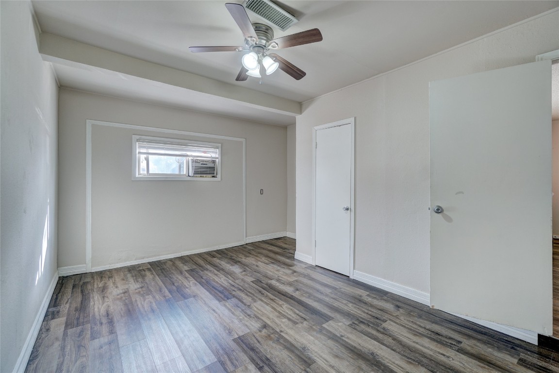 2505 N Hammond Avenue, Oklahoma City, OK 73127 unfurnished room featuring dark hardwood / wood-style floors and ceiling fan