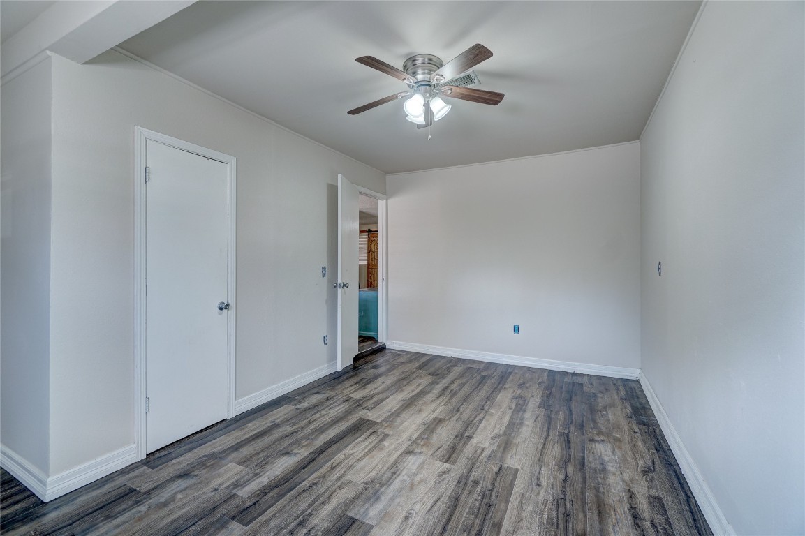 2505 N Hammond Avenue, Oklahoma City, OK 73127 unfurnished bedroom featuring dark hardwood / wood-style floors and ceiling fan