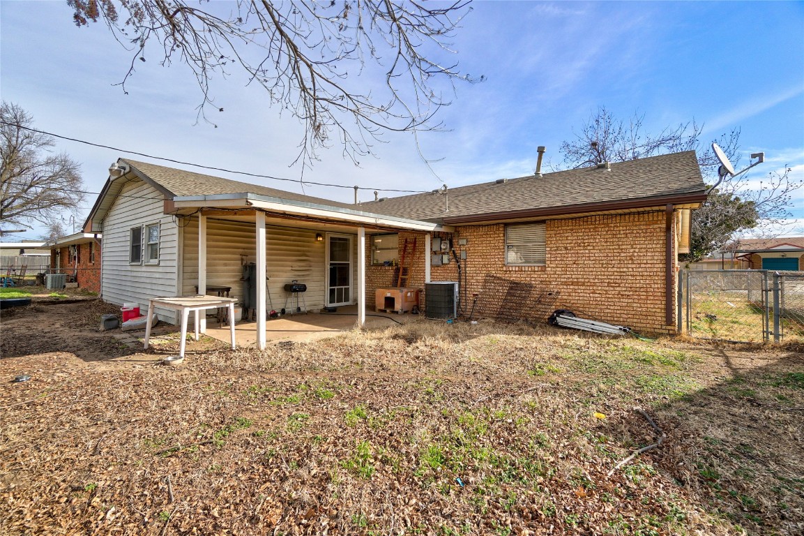 2505 N Hammond Avenue, Oklahoma City, OK 73127 rear view of house featuring central air condition unit and a patio