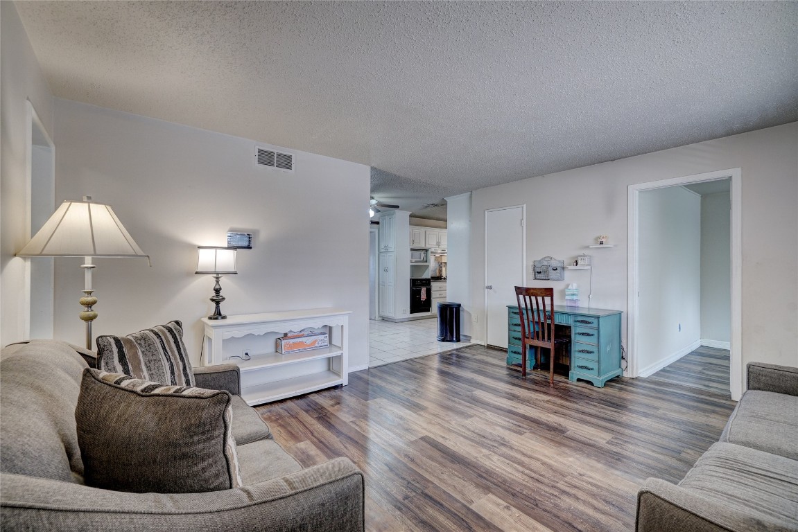 2505 N Hammond Avenue, Oklahoma City, OK 73127 living room featuring dark hardwood / wood-style floors and a textured ceiling