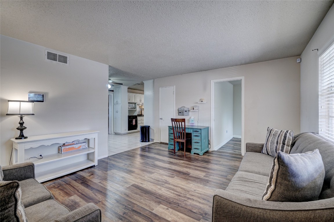 2505 N Hammond Avenue, Oklahoma City, OK 73127 living room featuring dark hardwood / wood-style floors and a textured ceiling