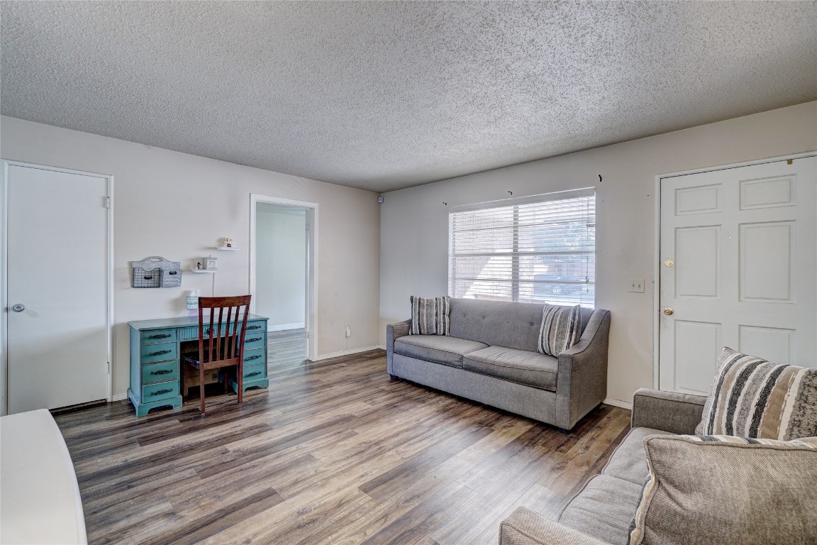 2505 N Hammond Avenue, Oklahoma City, OK 73127 living room featuring dark wood-type flooring and a textured ceiling