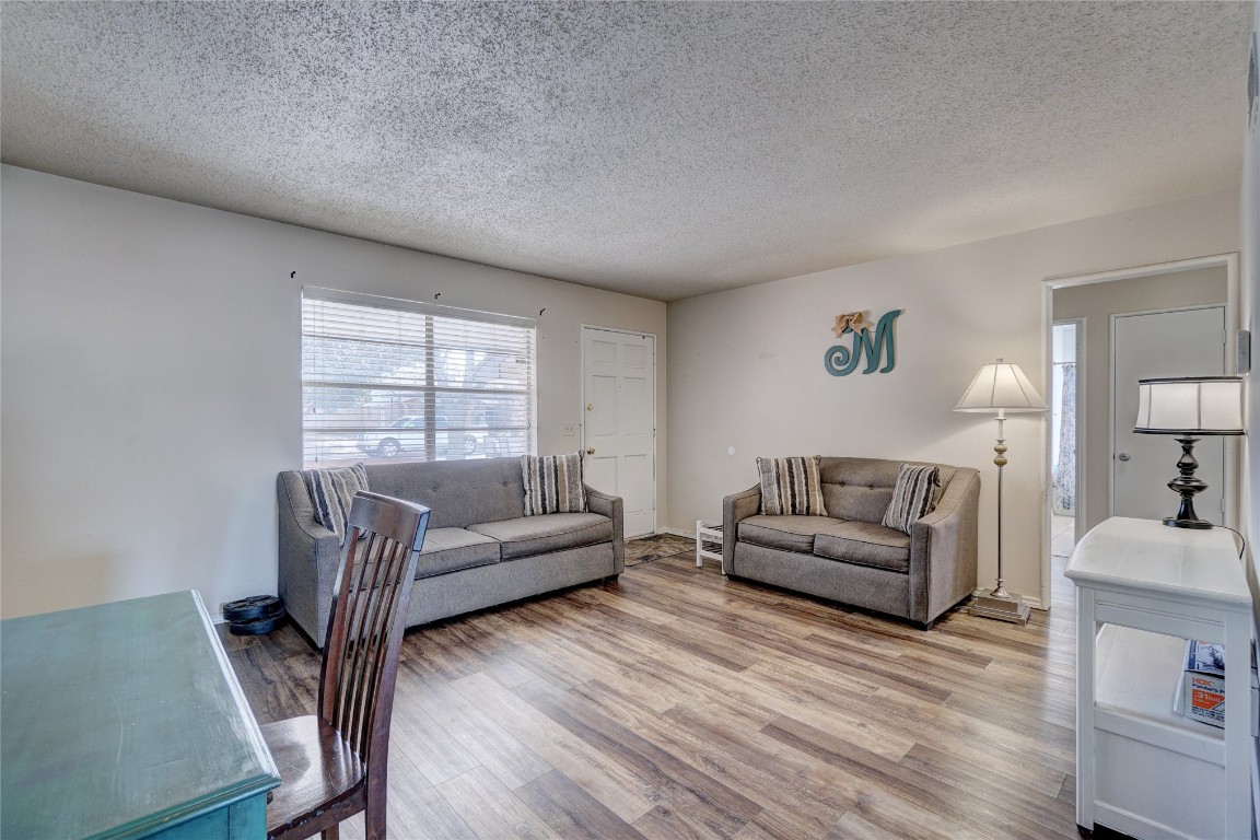 2505 N Hammond Avenue, Oklahoma City, OK 73127 living room featuring light wood-type flooring and a textured ceiling