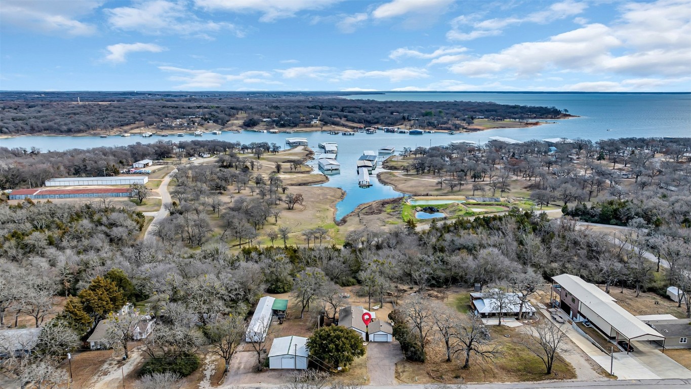 Situated in the highly desirable Soldier/Caney Creek area on Lake Texoma, is an impeccably maintained residence that is sure to captivate your attention. This extraordinary abode boasts an expansive deck that offers breathtaking views of the lush wooded backyard, providing a serene ambiance for relaxation. An inviting fire pit harmoniously blending with the surrounding property is the perfect place to gather around in the evenings. This home is set in the perfect landscape to host memorable gatherings and entertain with style.