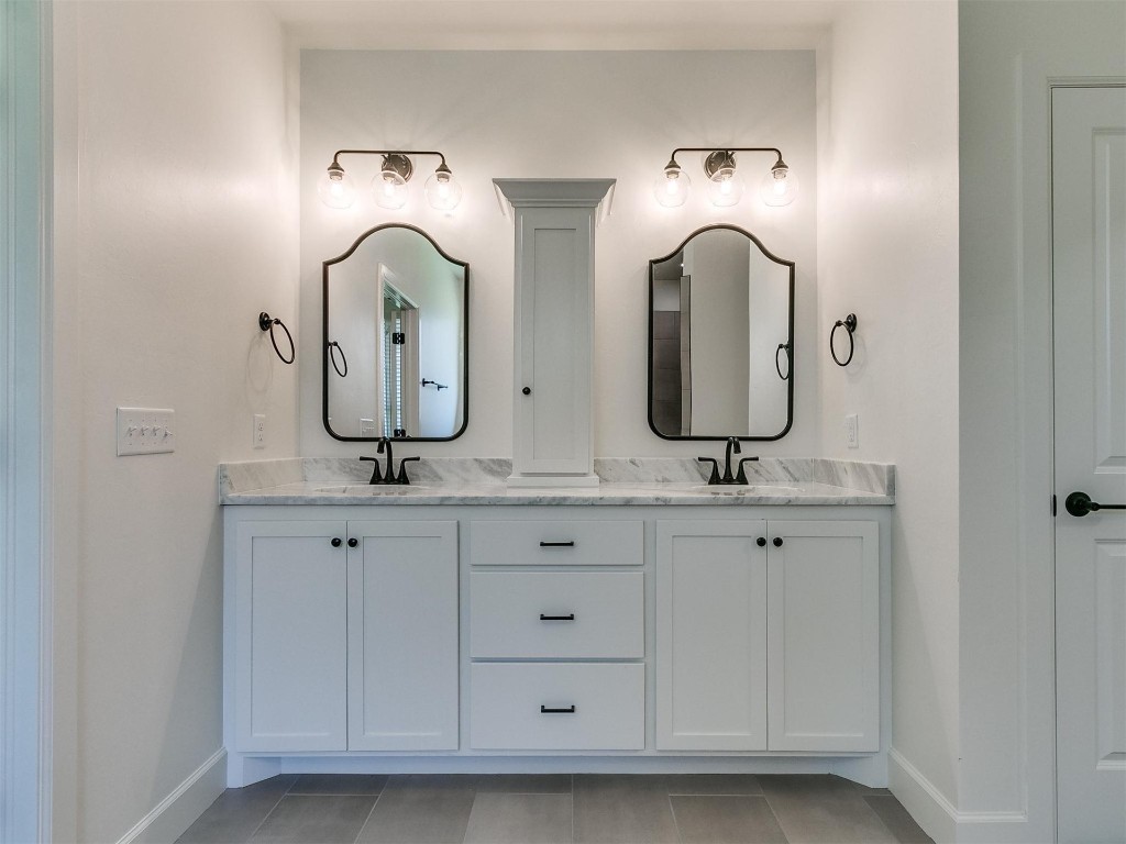 1226 Deer Ridge Boulevard, Tuttle, OK 73089 bathroom featuring oversized vanity, double sink, and tile flooring