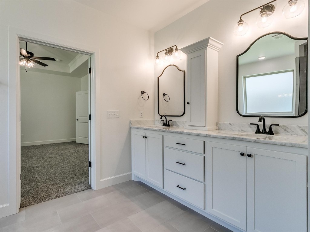 1226 Deer Ridge Boulevard, Tuttle, OK 73089 bathroom featuring large vanity, tile floors, ceiling fan, and double sink