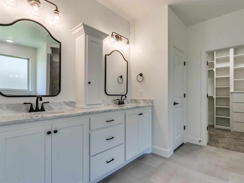 1226 Deer Ridge Boulevard, Tuttle, OK 73089 bathroom featuring dual vanity and tile flooring